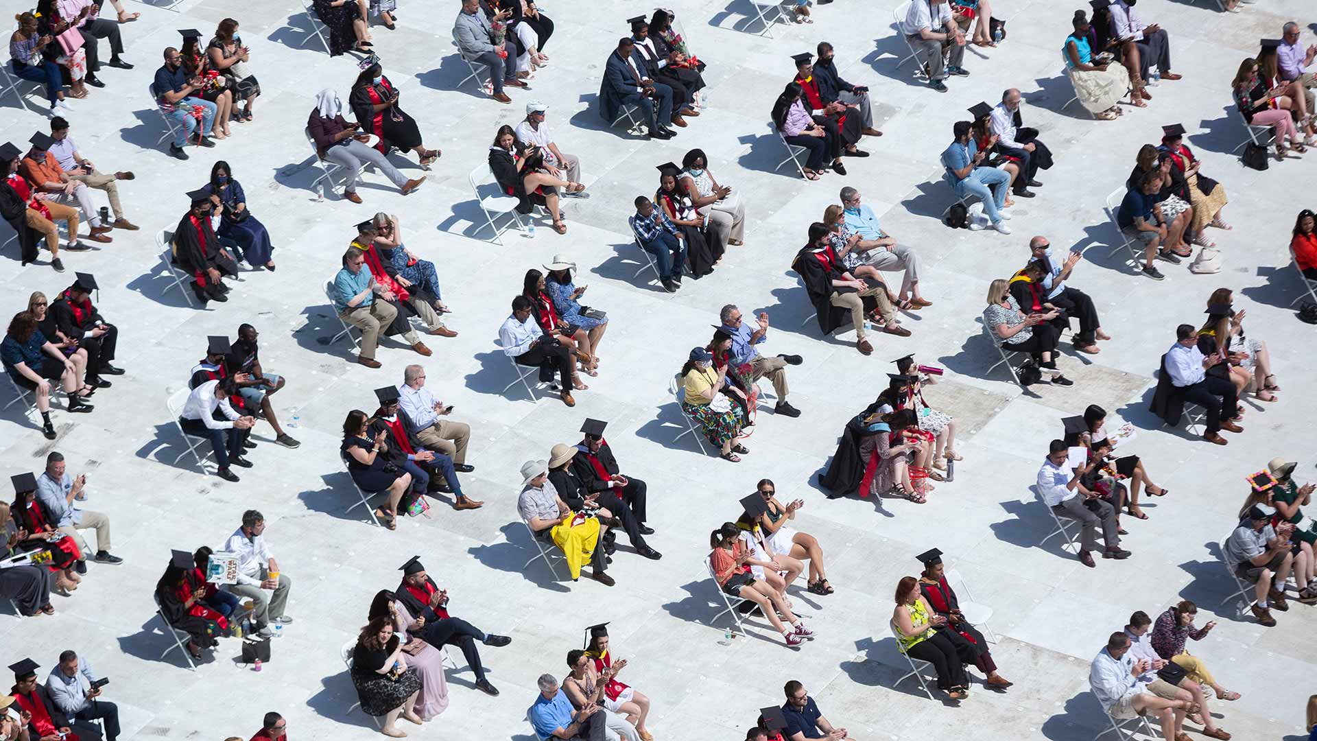Students sit spaced apart at commencement
