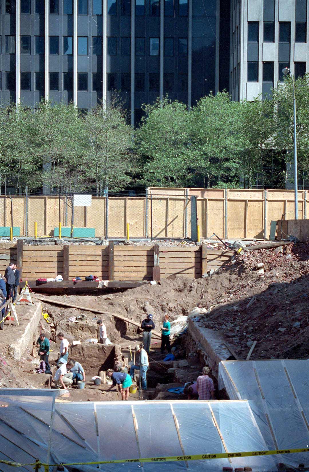 Workers dig and sift on a new federal office building site