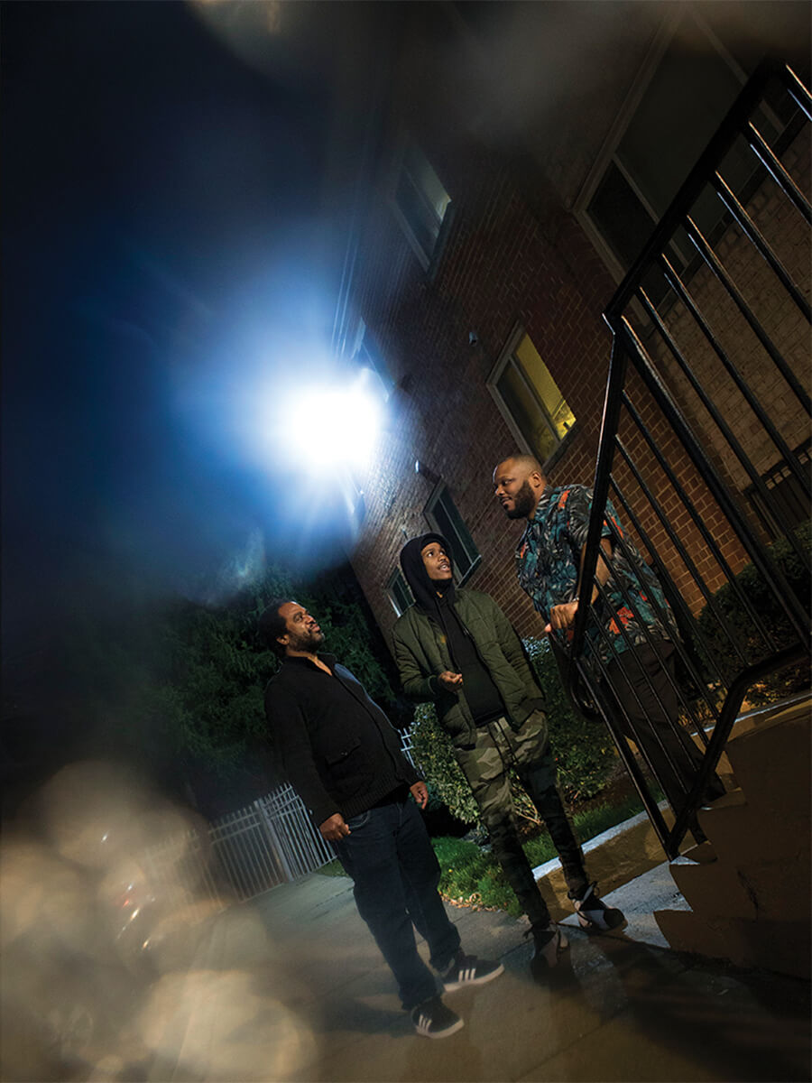 Richardson, left, talks with Chris Edge, center, and Che Bullock, a senior violence intervention specialist. 