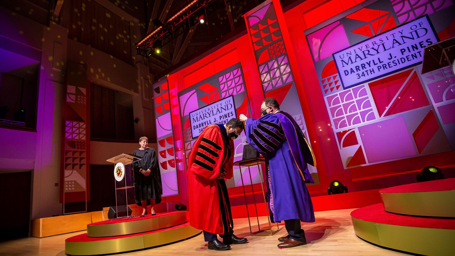 Jay A. Perman places medal around Darryll Pines' neck during investiture ceremony