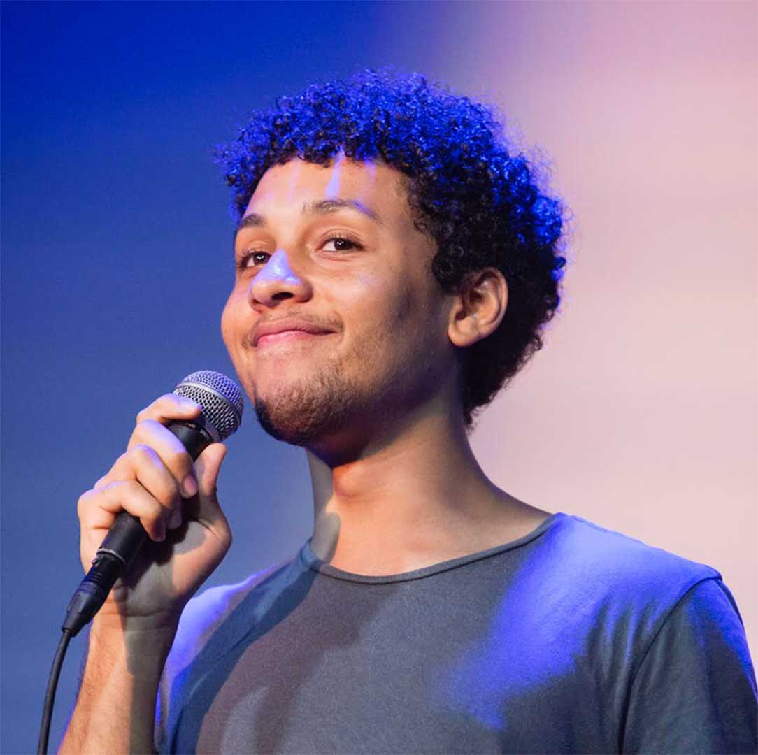 Jaboukie Young-White holds a microphone