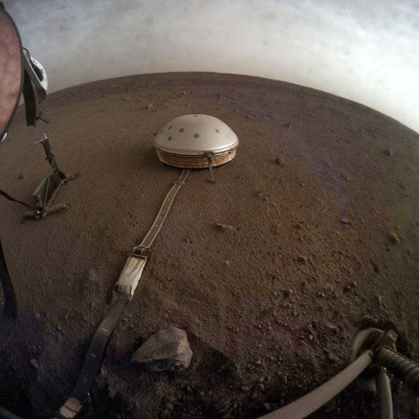 NASA's InSight Mars Lander used its Instrument Context Camera beneath the lander's deck to image these drifting clouds at sunset on the Red Planet.