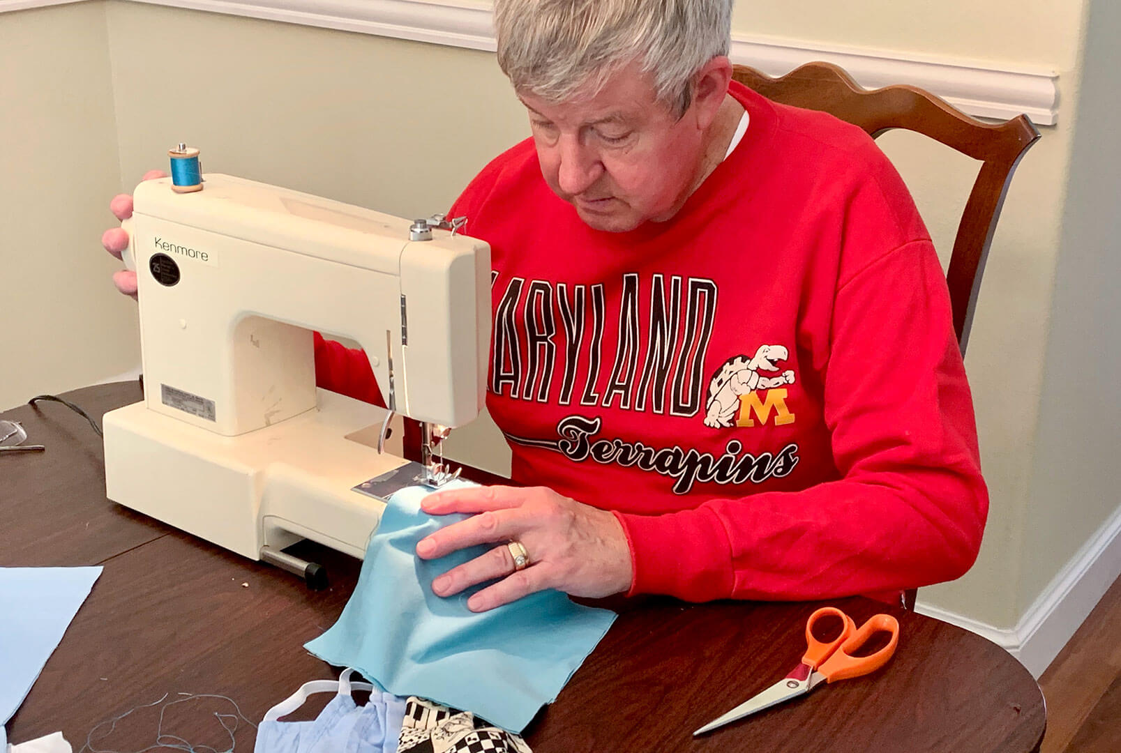 Man sewing a cloth mask