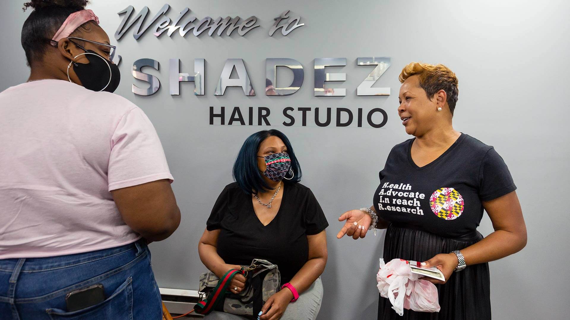 Long’s granddaughter, Jaelyn Moses (at left), and Moses’ mother, Chantell Long (center), talk to salon owner and community health advocate Katrina Randolph, a participant in UMD’s HAIR program.