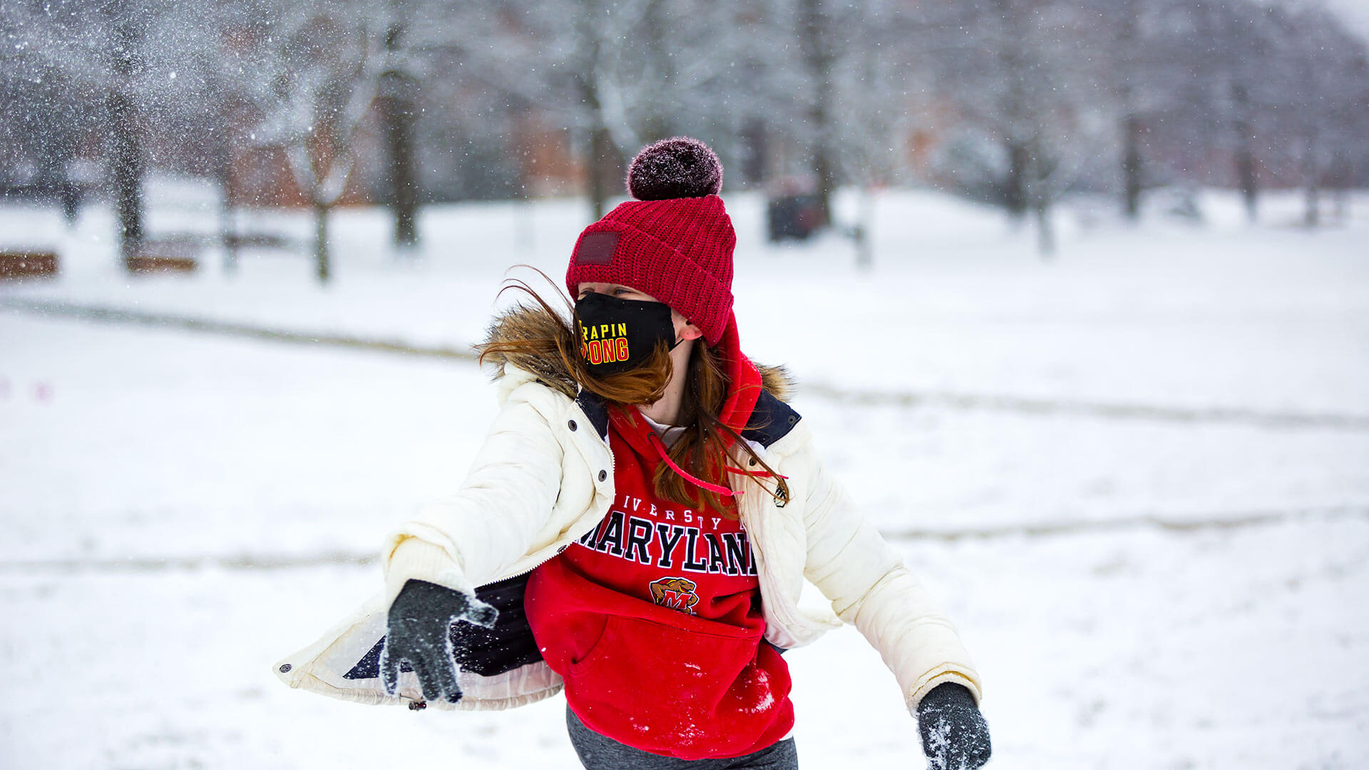 Student throws a snowball on McKeldin Mall