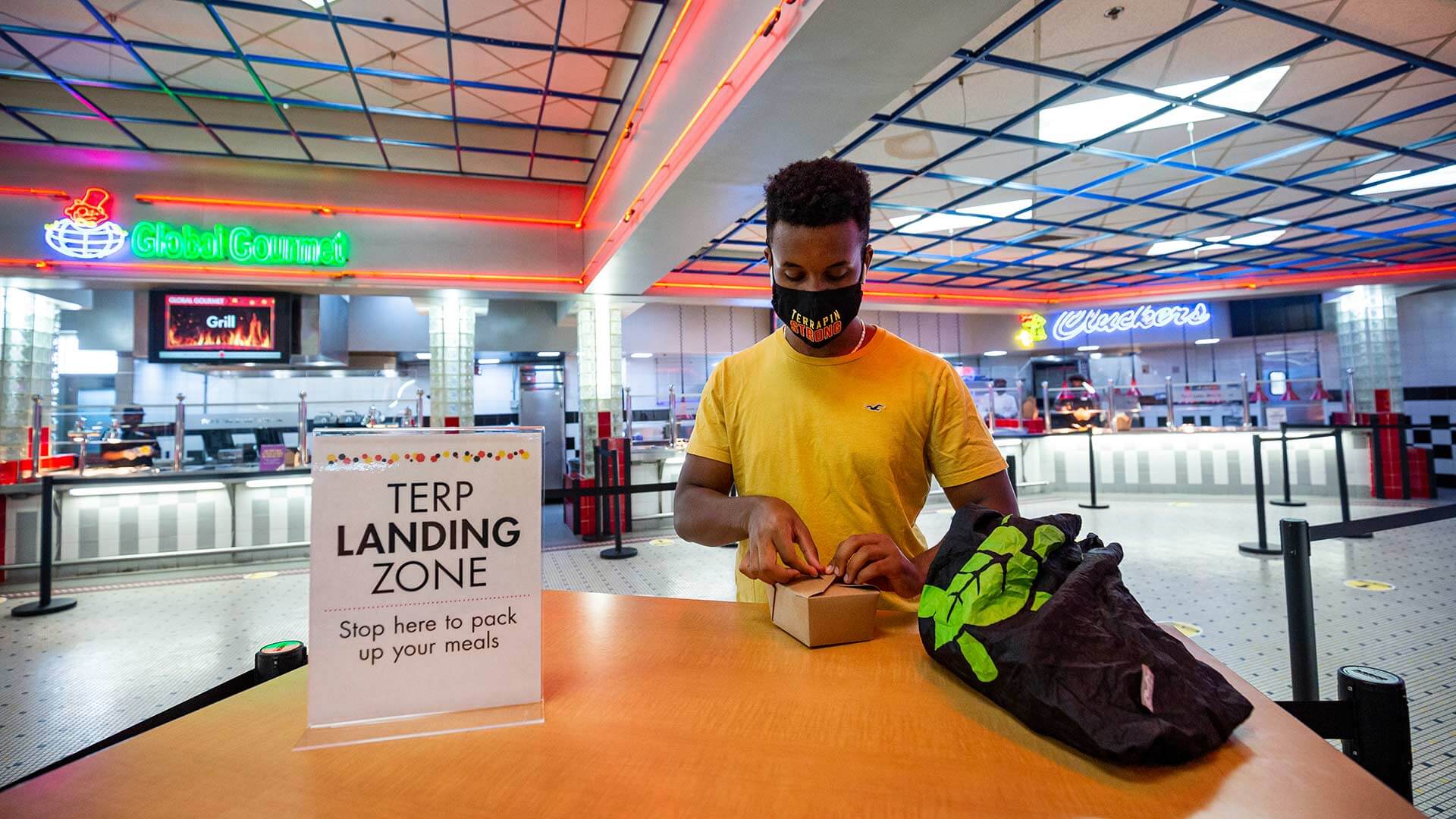 Student packs up food at dining hall