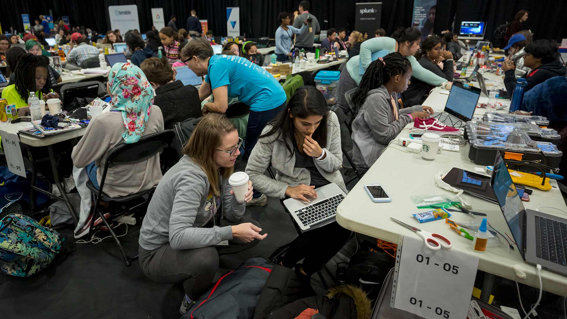 Aasta Frascati-Robinson, left, of Connecticut, works with Drithi Iyer, a graduate student at George Washington University, to code software that works with internet-connected light-up shoes for kids.
