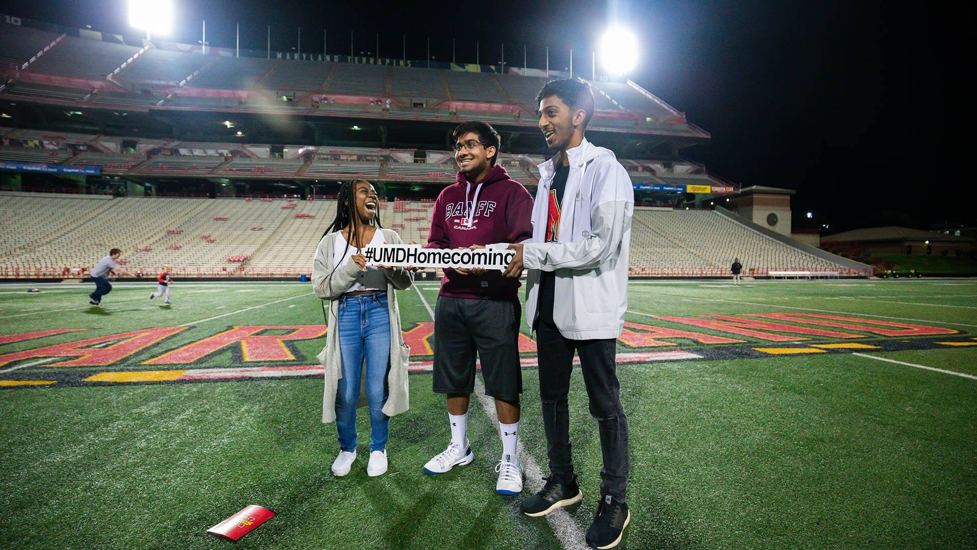 Students pose on the football field