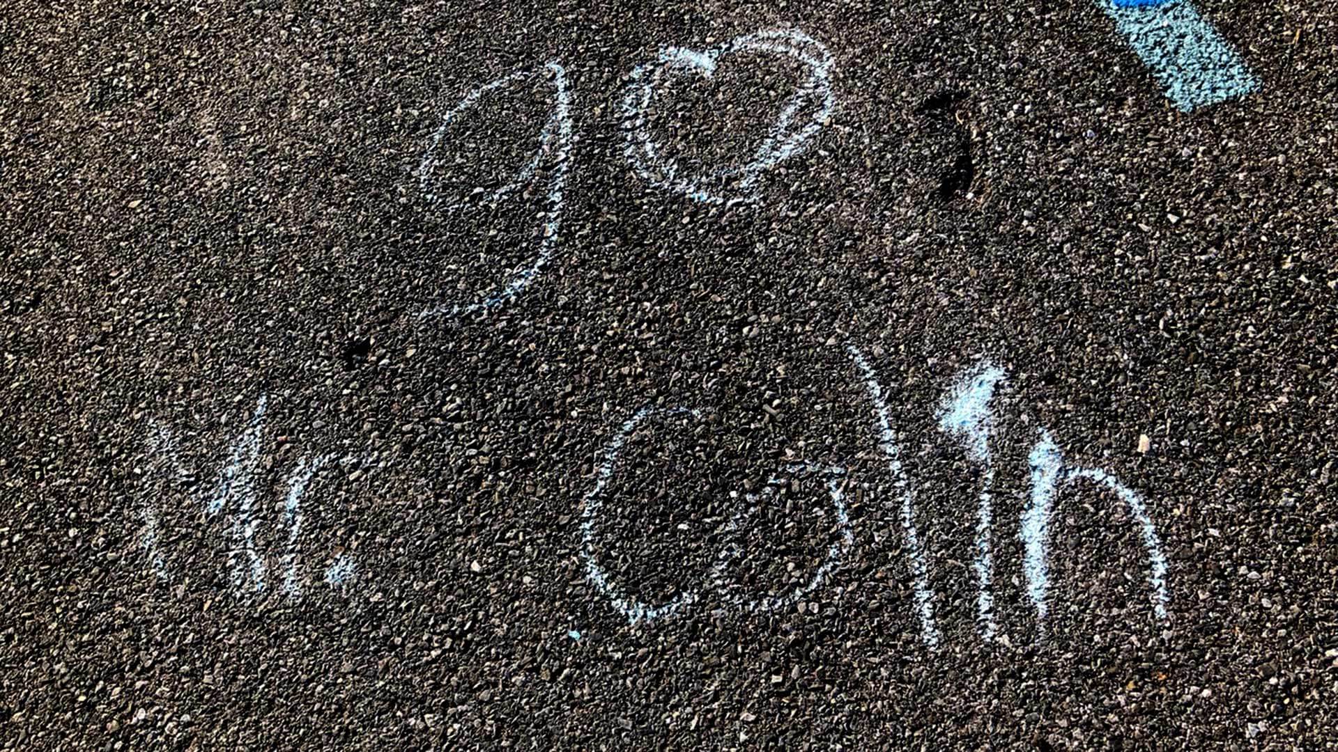 Message written in chalk reading, "Go Mr. Colin"